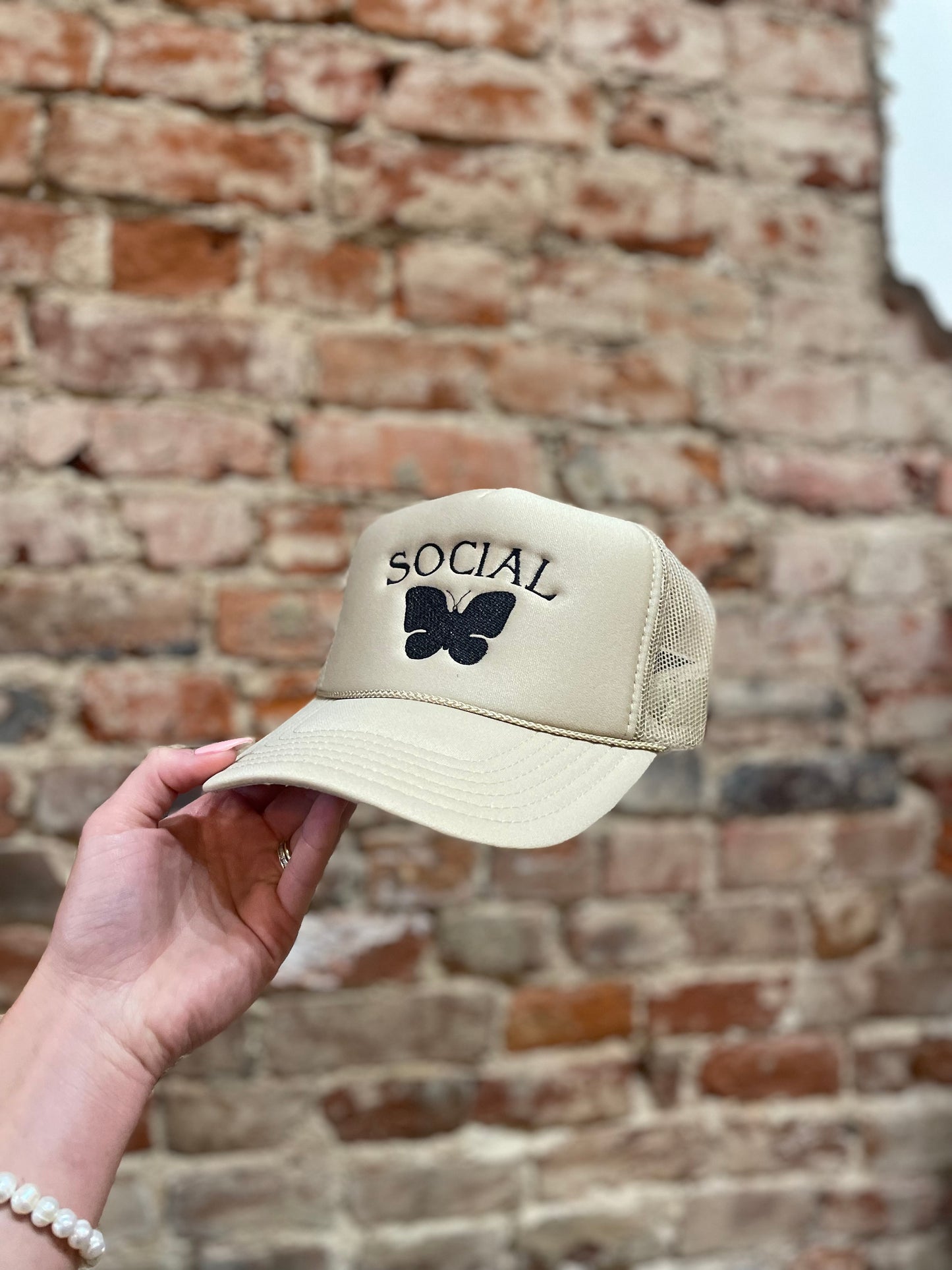SOCIAL BUTTERFLY TAN TRUCKER HAT