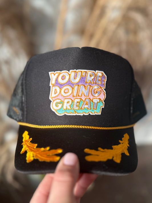 YOU'RE DOING GREAT BLACK/GOLD TRUCKER HAT
